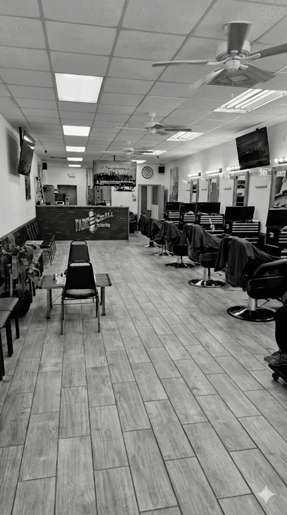 The academy's clinic floor with rows of barber chairs and stations